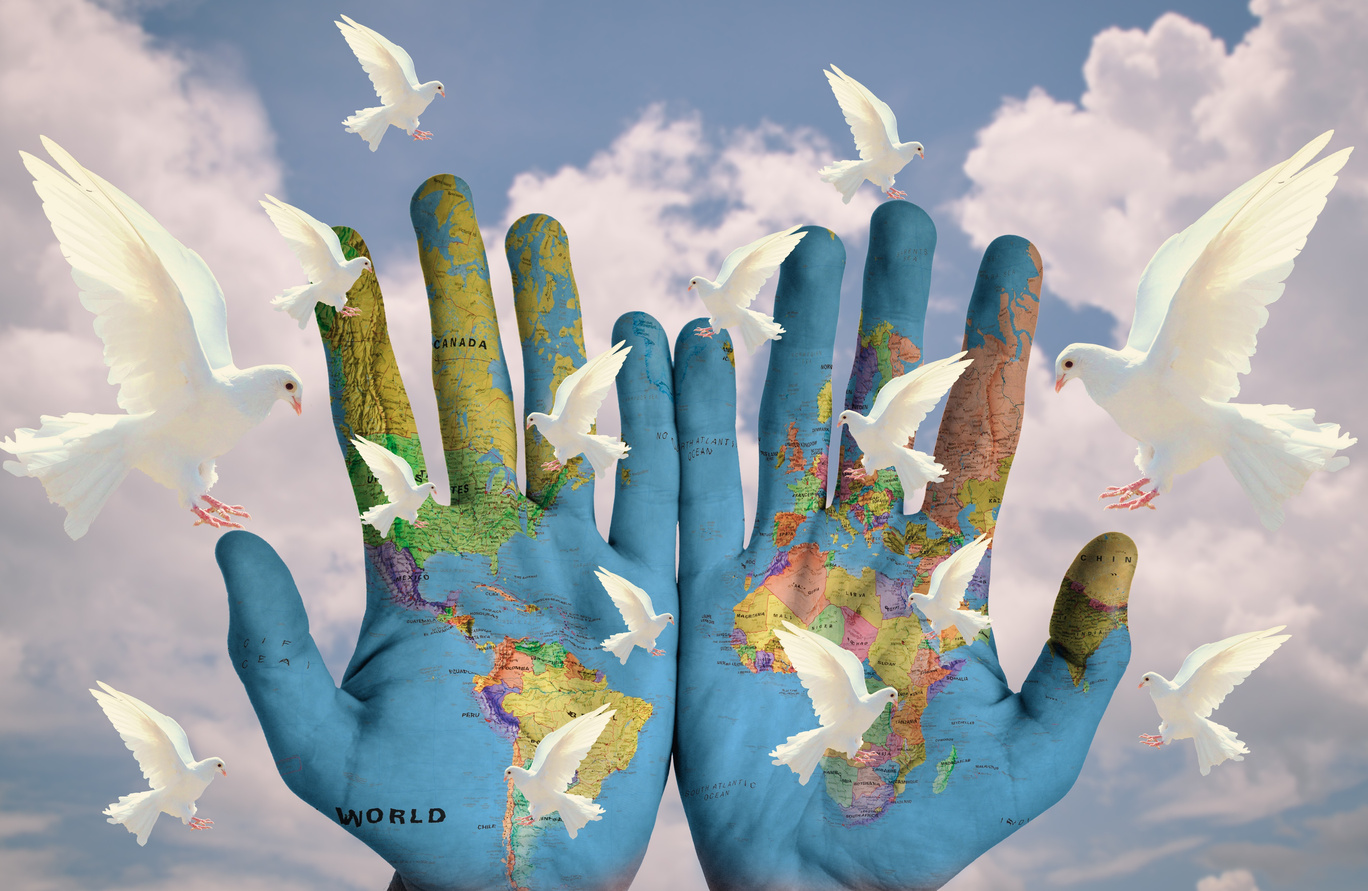 Photomontage Of Hands With World Map And Pigeons